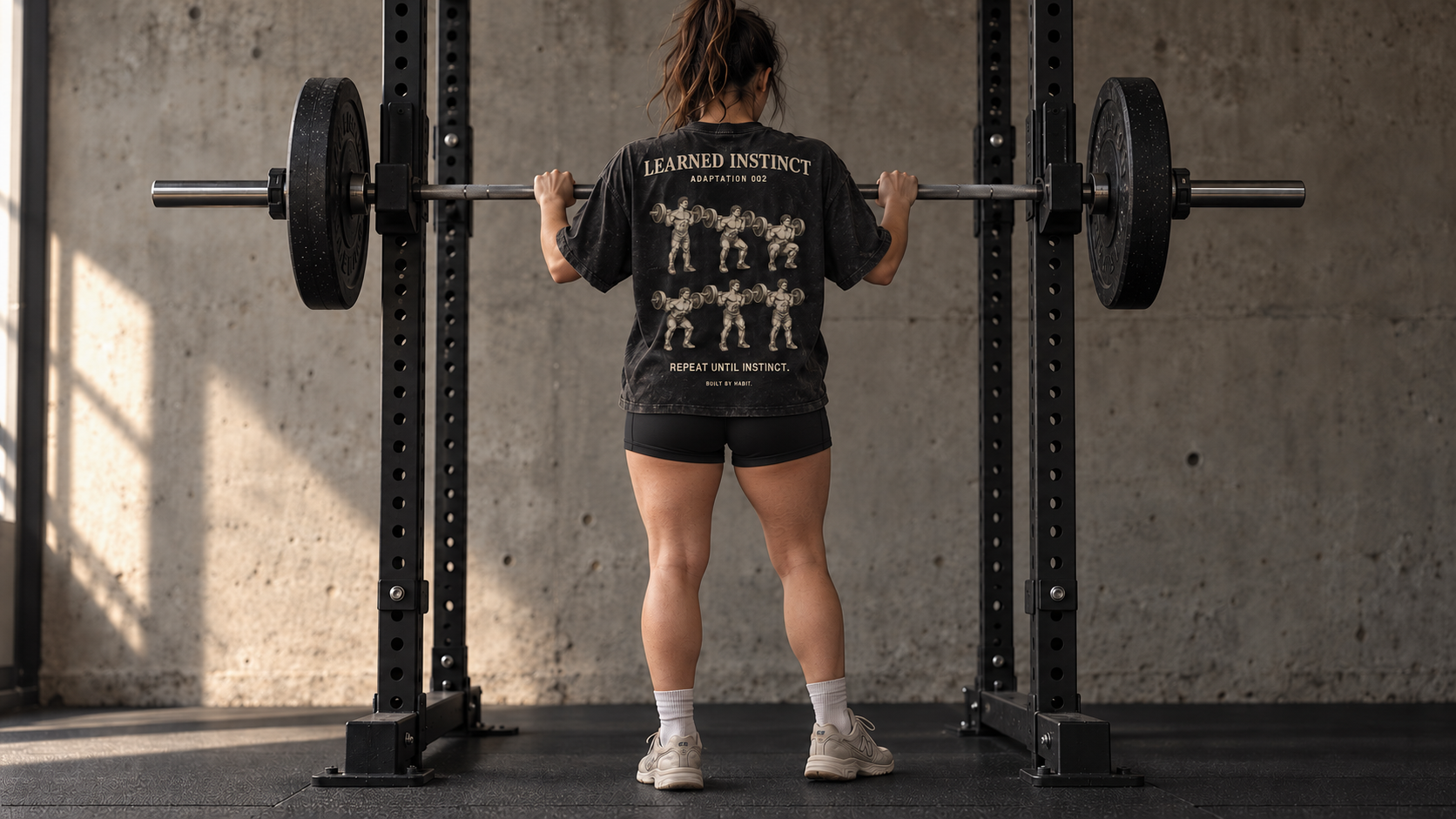 Athlete wearing the Adaptation 002 tee at a squat rack